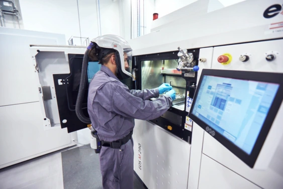 AM Technician Operating a Laser Powder Bed Fusion Platform at Burloak. 